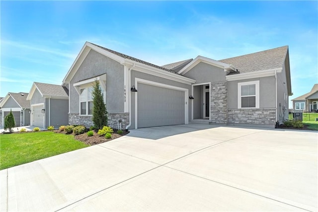 16955 W 168th Ter, Olathe, KS 66062 - ranch-style home with stone siding, concrete driveway, a garage, stucco siding, and a front lawn