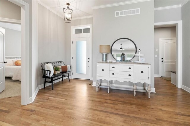 16955 W 168th Ter, Olathe, KS 66062 - living area with ornamental molding, baseboards, light wood-style flooring, and visible vents
