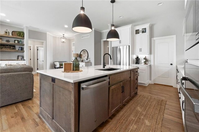 16955 W 168th Ter, Olathe, KS 66062 - kitchen featuring stainless steel appliances, wood finished floors, visible vents, and a sink