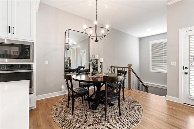 16955 W 168th Ter, Olathe, KS 66062 - dining space with light wood finished floors, a wealth of natural light, baseboards, and a notable chandelier