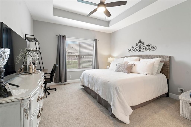 16955 W 168th Ter, Olathe, KS 66062 - bedroom with a tray ceiling, light carpet, baseboards, and a ceiling fan
