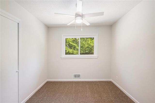 carpeted empty room featuring baseboards, a ceiling fan, and a textured ceiling