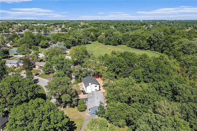 aerial view of property's location featuring a heavily wooded area