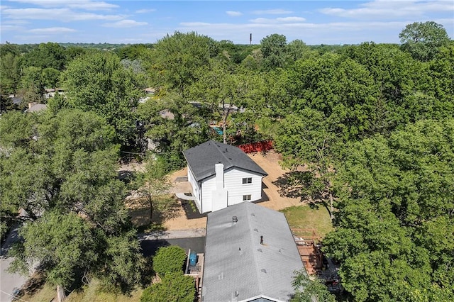 view of subject property featuring a heavily wooded area