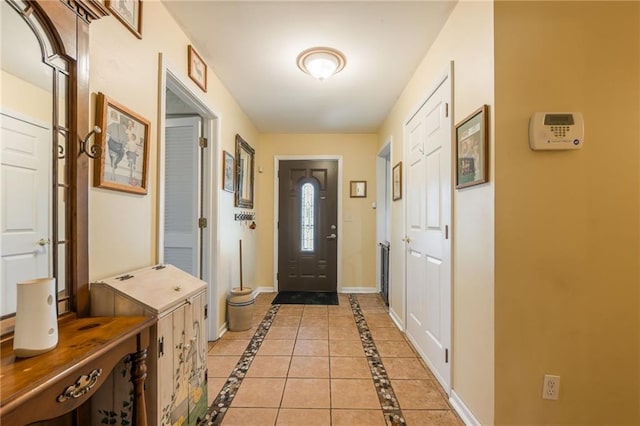 doorway to outside featuring baseboards