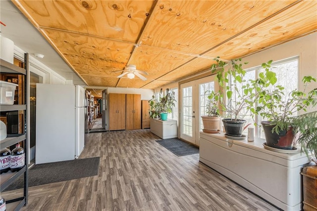 sunroom / solarium featuring french doors and a healthy amount of sunlight