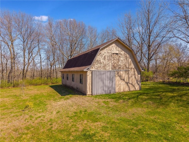 view of barn with a lawn