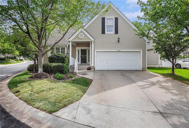 traditional-style home with concrete driveway, a front yard, and a garage