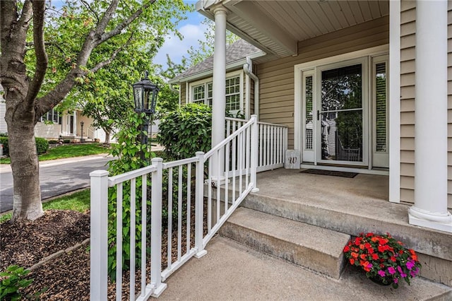 doorway to property with roof with shingles
