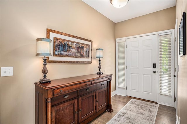 entrance foyer with baseboards and light wood-type flooring