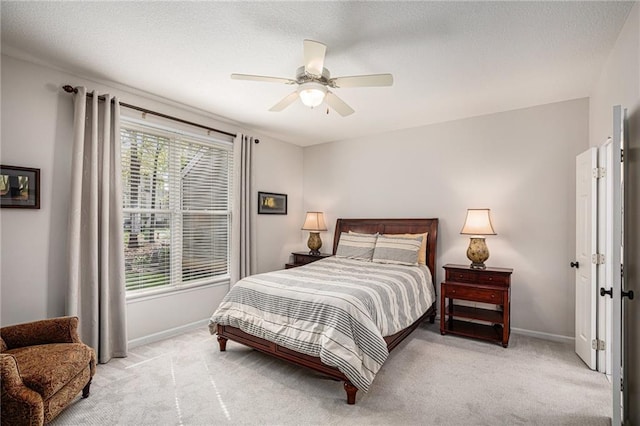 bedroom with baseboards, light carpet, and ceiling fan