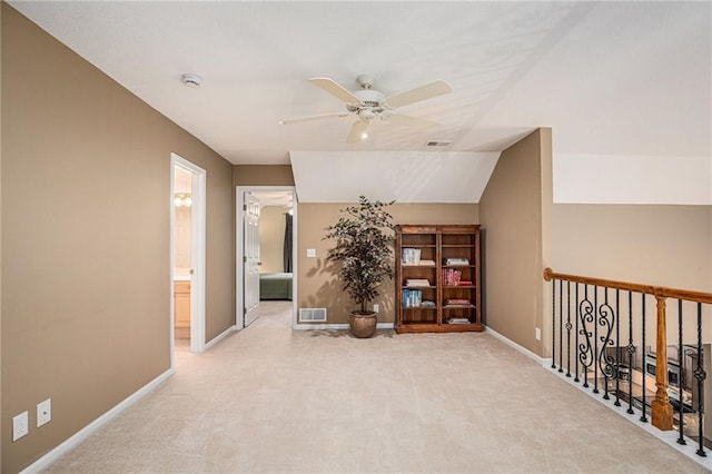 interior space featuring ceiling fan, visible vents, baseboards, and carpet