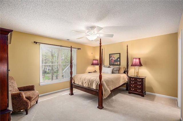 carpeted bedroom with baseboards, a textured ceiling, and ceiling fan