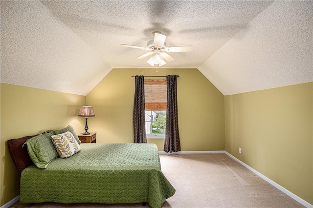 bedroom featuring carpet floors, a textured ceiling, ceiling fan, and lofted ceiling