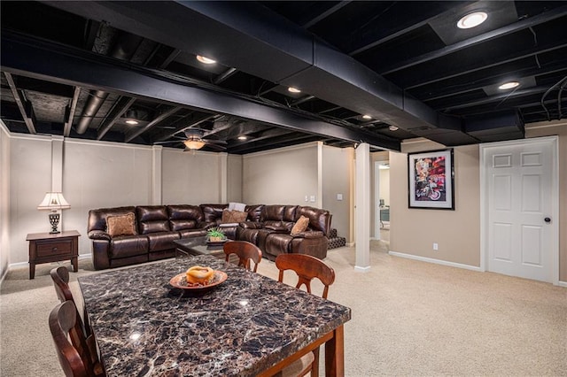 dining area with baseboards and light carpet