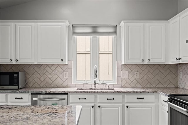 kitchen featuring a sink, stainless steel appliances, and white cabinetry