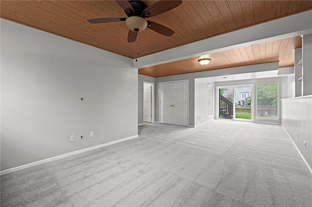 carpeted empty room with wood ceiling, baseboards, and ceiling fan
