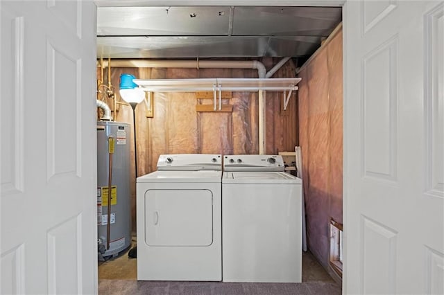 clothes washing area with washing machine and clothes dryer, laundry area, and water heater