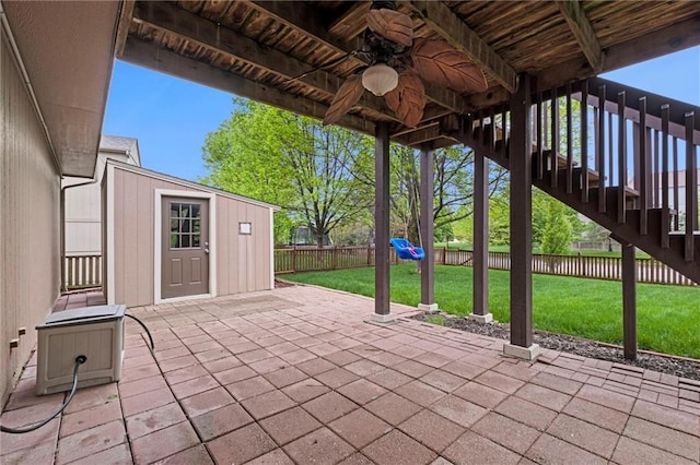 view of patio with stairway, ceiling fan, and a fenced backyard