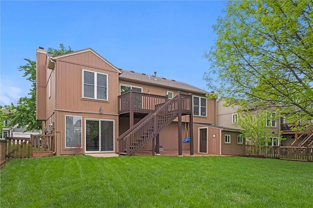 back of house with a wooden deck, stairs, a lawn, and a fenced backyard