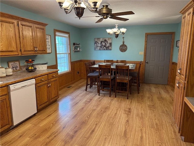12301 S Stubbs Rd, Overbrook, KS 66524 - dining area featuring a chandelier, a wainscoted wall, light wood-style flooring, and a ceiling fan