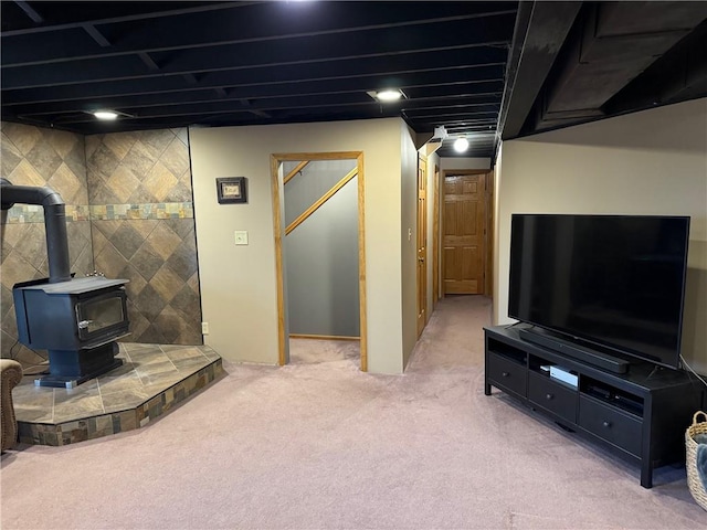 12301 S Stubbs Rd, Overbrook, KS 66524 - finished below grade area featuring light carpet and a wood stove