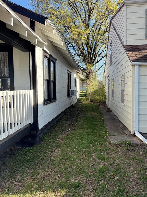 view of side of property with a yard