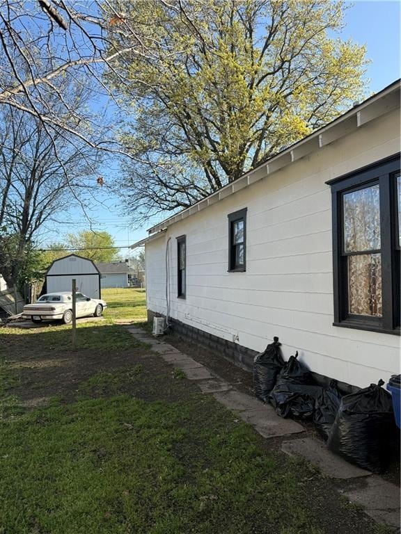 view of side of home with a lawn