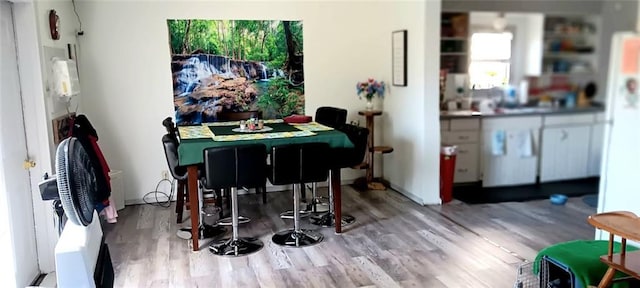 dining area with wood finished floors
