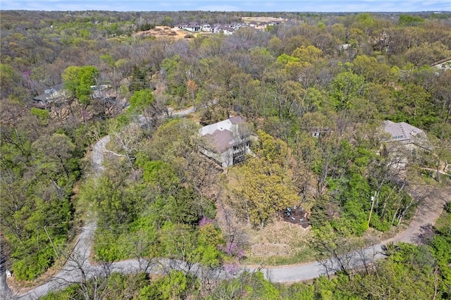bird's eye view with a wooded view