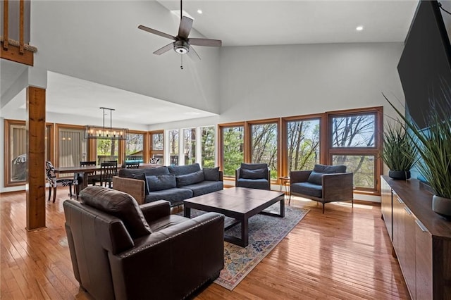 living room featuring a ceiling fan, high vaulted ceiling, recessed lighting, and light wood finished floors