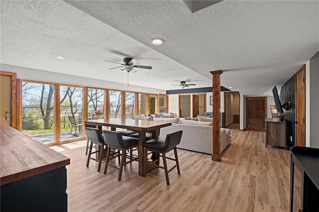 dining space featuring a ceiling fan, a textured ceiling, recessed lighting, and light wood-type flooring