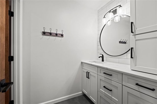 bathroom featuring vanity, baseboards, and tile patterned floors