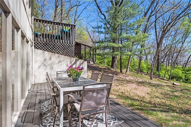 wooden terrace with outdoor dining area
