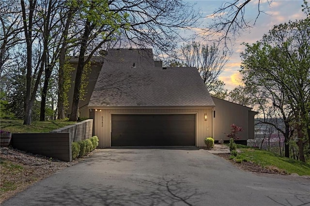 view of home's exterior with a garage and driveway