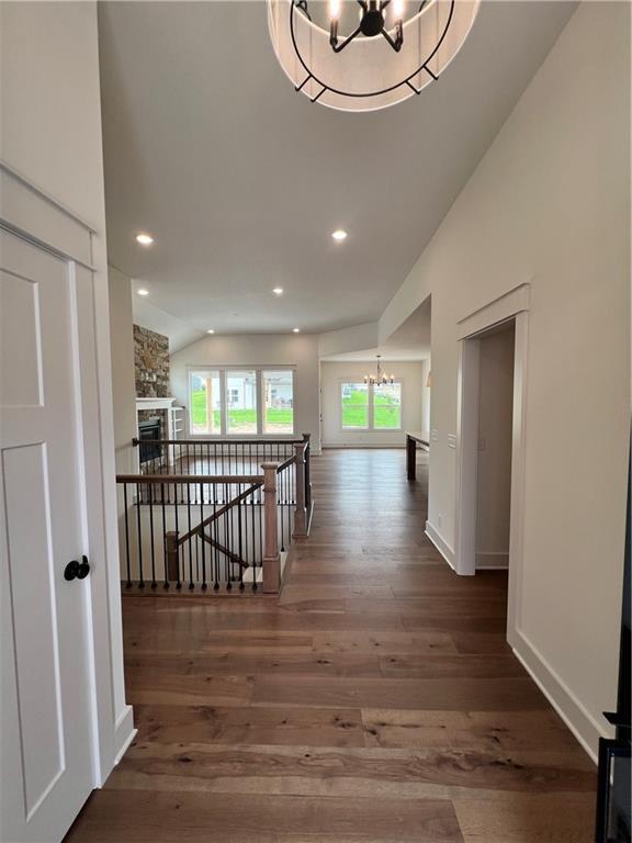 16372 Spring Valley St, Gardner, KS 66030 - hallway featuring a chandelier, vaulted ceiling, wood finished floors, recessed lighting, and baseboards