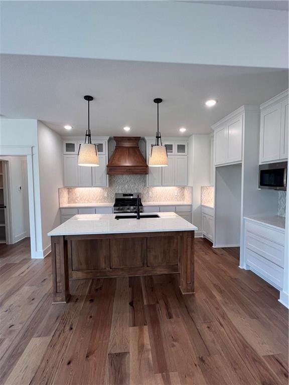 16372 Spring Valley St, Gardner, KS 66030 - kitchen with custom exhaust hood, stainless steel appliances, a sink, white cabinetry, and decorative backsplash