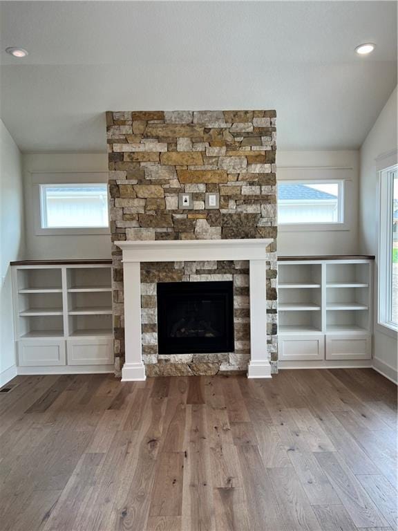 16372 Spring Valley St, Gardner, KS 66030 - detailed view of wood finished floors, baseboards, a fireplace, and recessed lighting