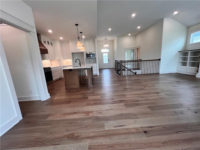 16372 Spring Valley St, Gardner, KS 66030 - kitchen featuring stainless steel microwave, open floor plan, healthy amount of natural light, and recessed lighting