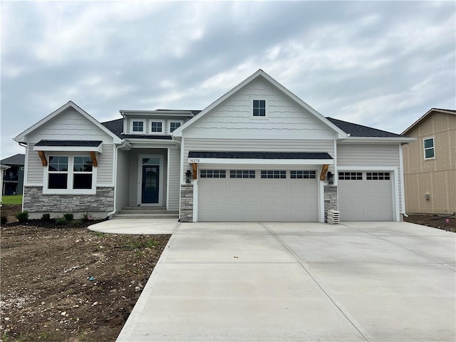 16372 Spring Valley St, Gardner, KS 66030 - craftsman inspired home with a garage, stone siding, and concrete driveway