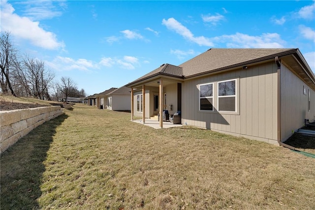 9331 N Belton Ave, Kansas City, MO 64154 - back of property with a patio, a shingled roof, and a yard