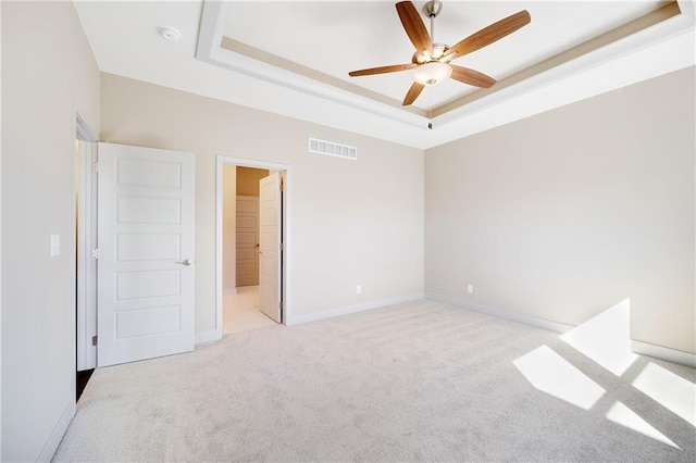 9331 N Belton Ave, Kansas City, MO 64154 - unfurnished bedroom with baseboards, visible vents, light carpet, and a raised ceiling