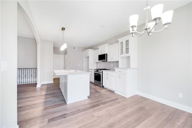 9335 N Belton Ave, Kansas City, MO 64154 - kitchen with light countertops, a sink, light wood finished floors, and stainless steel appliances