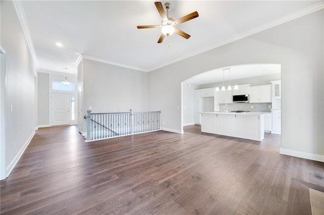 9335 N Belton Ave, Kansas City, MO 64154 - unfurnished living room featuring crown molding, a ceiling fan, and dark wood finished floors
