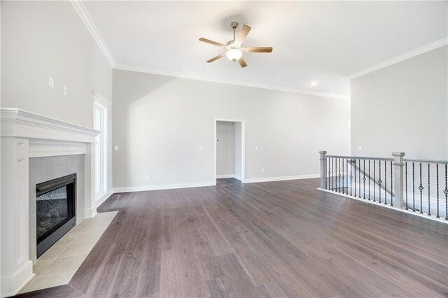 9335 N Belton Ave, Kansas City, MO 64154 - unfurnished living room featuring crown molding, ceiling fan, a fireplace, baseboards, and wood finished floors