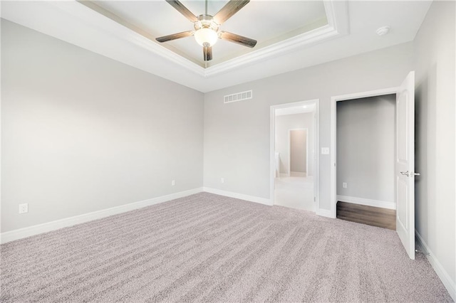 9335 N Belton Ave, Kansas City, MO 64154 - unfurnished bedroom with a raised ceiling, ensuite bath, carpet floors, baseboards, and visible vents