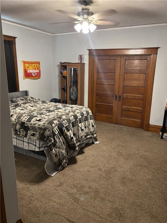 1023 Webster St, Chillicothe, MO 64601 - bedroom with crown molding, carpet flooring, and a ceiling fan