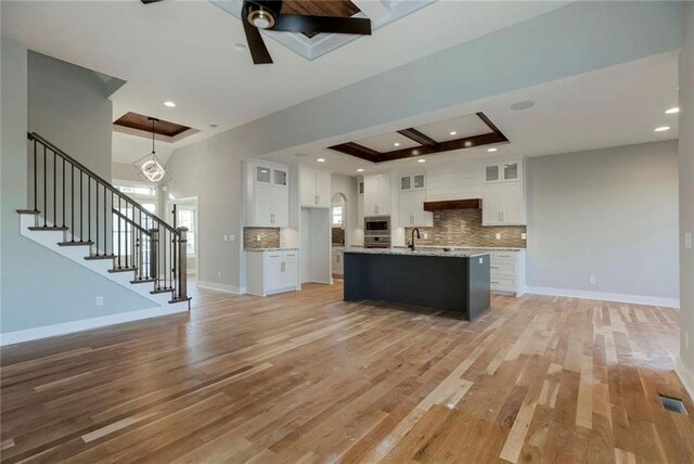 3217 SW Saddlebred Ter, Lees Summit, MO 64082 - kitchen with open floor plan, light wood-style flooring, backsplash, and recessed lighting