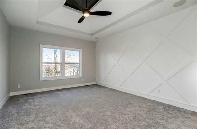 3217 SW Saddlebred Ter, Lees Summit, MO 64082 - carpeted spare room with a tray ceiling, baseboards, and a ceiling fan