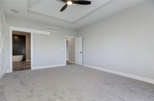 3217 SW Saddlebred Ter, Lees Summit, MO 64082 - unfurnished bedroom with carpet, a tray ceiling, baseboards, and a ceiling fan